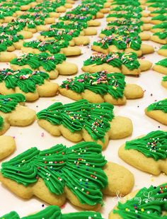 green frosted christmas tree cookies with sprinkles