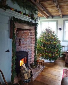 a living room filled with furniture and a christmas tree on top of a fire place