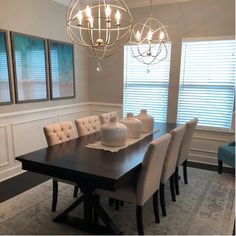 a dining room table with six chairs and a chandelier