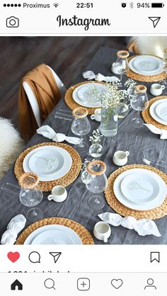 an instagram photo of a table set with white plates and silverware