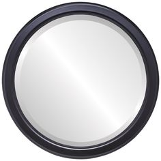 a round mirror is shown on a white background with black trimming and an oval frame