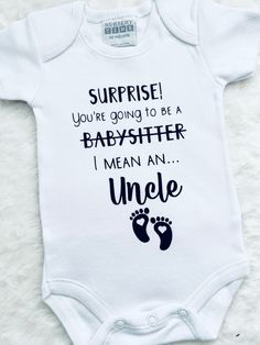 a white bodysuit with the words surprise you're going to be a babysither i mean an uncle