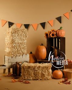 pumpkins, hay bales and decorations on display