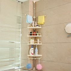 there is a shelf in the shower with bottles on it