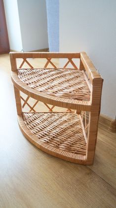 a wicker shelf sitting on top of a hard wood floor next to a wall