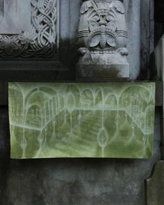 an image of a painting on the wall in front of a stone building with carvings