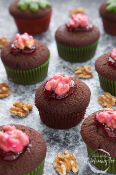 chocolate cupcakes with raspberry filling and walnuts on the side, ready to be eaten