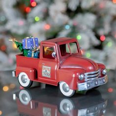 a red toy truck with presents in the back