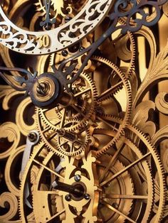 an intricate clock with gold and silver gears