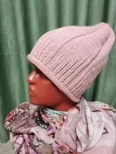 a mannequin head wearing a pink knitted hat