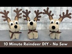 three stuffed reindeers with brown bows and antlers on their heads, standing next to each other