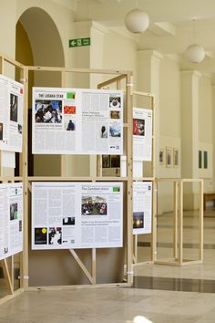 a group of posters sitting on top of a wall next to each other in a room