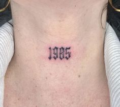 a woman's chest with the word god tattooed on her left side ribcage