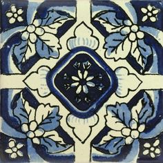 a blue and white tile design with flowers on it's side, in the center