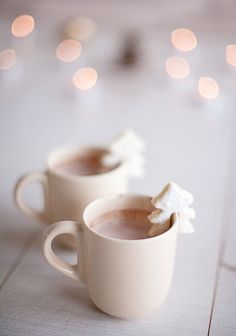 two white mugs filled with hot chocolate