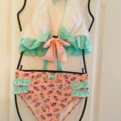 Cute And Sexy Pinup Style Bikini , Bottoms Have A Fun Vintage Ice Cream Pattern With Riffled Hips, Top Is Halter Style So It Accentuates The Bust In A Pretty Pastel Of Pink, White And Sea Foam Green White Stretch Tankini With Tie-side Bottom, Fitted White Tankini, White Beachy Tankini With Tie-side Bottom, White Tie-side Bottom Tankini For Beach, White Tankini For Pool With Tie-side Bottom, White Tankini With Tie-side Bottom For The Pool, White Tie-side Bottom Tankini For Pool, White Fitted Tankini For Beach Party, Fitted White Tankini For Beach Party