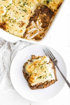 a casserole dish with meat, cheese and onions in it on a white plate