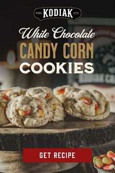 white chocolate candy corn cookies are sitting on a wooden platter, with the title get recipe