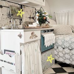 a kitchen with an oven next to a bed and a checkerboard pattern floor