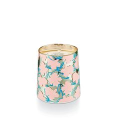 a pink and blue floral candle holder on a white background with gold trimmings