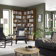 a living room filled with furniture and a book shelf