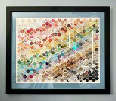 a framed art piece with hexagons on the top and bottom, all in different colors