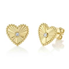 Add a romantic touch to you jewelry collection with these earrings from Shy Creation. Crafted in gleaming 14k yellow gold, these stud earrings each feature a twinkling round diamond set in the center of the sunburst heart motifs. The diamonds are 1/20ctw, H in color, and SI2 in clarity. These earrings measure 0.40 inches in length and 0.40 inches in width. Gold Sunburst, Round Diamond Setting, Studded Necklace, Heart Stud Earrings, Deco Jewelry, Heart Studs, Bezel Diamond, Heart Earrings Studs, Art Deco Jewelry