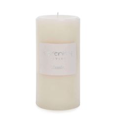 a large white candle with a label on the top and bottom that says serenity