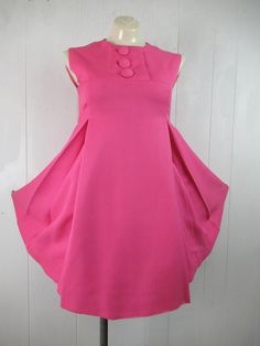 "Vintage 1960s pink baby doll dress. Made of thick linen/Rayon. Has an empire waist, back zipper, pleated front and back. Made by Donnie Brooks, sold at Saks Fifth Avenue. Size small. Actual measurements are: 34\" at the bust 30\" at the waist 37\" around the hips 14\" shoulder to shoulder 34.5\" overall length In very good condition." Pink Pleated Knee-length Mini Dress, Pink Fitted Dress With Box Pleat, Spring Pink Pleated Back Dress, Spring Pink Dress With Pleated Back, Spring Pink Dresses With Pleated Back, Pink Mod Dress For Spring, 1960s Dress, Beauty Forever, 1970s Dresses