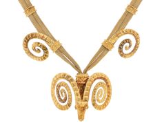 A stylized ram's head crafted of 18K yellow gold is the focal point of this remarkable necklace by legendary Greek jewelry house Zolotas. The elegantly braided gold chain is enhanced by thirteen patterns, the last one holding a ram's head surmounted by huge ram horns typical of classical and neoclassical styles. Since 1895, Zolotas has created luxurious masterpieces infused with the rich culture and history of Greece, and this piece is a testament to both their enduring legacy and forward-thinki Luxury Antique Jewelry With Wheat Chain, Handmade Walking Sticks, Ram Horns, Head Necklace, Ram Head, Animal Symbolism, Greek Jewelry, Majestic Animals, Neoclassical