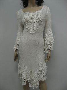 a mannequin wearing a white dress with lacy lace on it's sleeves