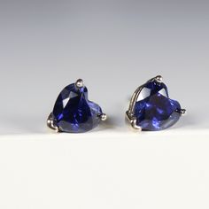 "These earrings feature a heart-shaped lab grown blue sapphire stone that sparkles and shines in the light. The heart shape of the sapphire stones adds a touch of romance and whimsy to the design, making them perfect for both casual and formal events. DETAILS ABOUT THE EARRINGS AND MATERIAL AND STONE * 14k SOLID GOLD Settings, posts and backings * 5x5mm heart shaped genuine lab grown blue sapphire We can had make it in White gold, Rose Gold or Yellow Gold. Please choose from drop down menu.   * Classic Blue Heart-shaped Jewelry, Heart Cut Tanzanite Jewelry Gift, Heart Cut Lab-created Sapphire Gemstone Jewelry, Blue Heart-cut Heart Earrings For Anniversary, Blue Heart Cut Earrings For Anniversary, Trillion Cut Fine Jewelry Earrings For Gift, Heart-shaped Lab-created Sapphire Gemstone Jewelry, Heart-shaped Lab-created Sapphire Jewelry For Valentine's Day, Heart-shaped Lab-created Sapphire Jewelry