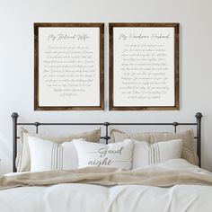 two framed pictures on the wall above a bed with white linens and pillow covers