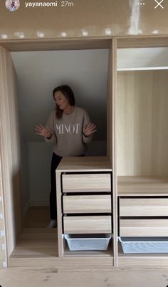 a woman standing inside of a wooden closet