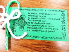 a green and white bookmark with a poem on it sitting on a wooden table