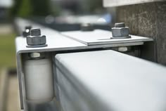 the metal brackets are attached to the side of the building's window sill