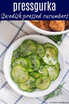 a bowl filled with sliced cucumbers next to another bowl full of pickles