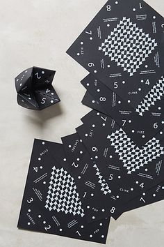 several pieces of black paper with white designs on them