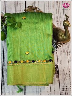 This elegant cotton jute silk saree in parrot green features a contrast blue pallu and border decorated with hand embroidered floral designs. The body of the saree is also adorned with hand embroidered floral designs for a timeless, sophisticated look. Its unique color combination and matching blouse piece in blue with hand embroidery on the sleeves make this saree truly special. Please note: Color may vary slightly from the picture. Thread knots ,Thread pulls and minor inconsistencies are chara Green Art Silk Pre-draped Saree With Embroidered Border, Designer Green Pre-draped Saree With Embroidered Border, Green Embroidered Pre-draped Saree, Green Resham Embroidered Cotton Silk Blouse Piece, Green Pre-draped Saree With Resham Embroidery For Diwali, Green Pre-draped Saree With Resham Embroidery, Green Chanderi Pre-draped Saree For Puja, Green Chanderi Pre-draped Saree For Festivals, Green Chanderi Embroidered Fabric For Designer Wear