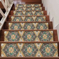 the stair treads are decorated with colorful tiles and designs on them, along with wooden handrails