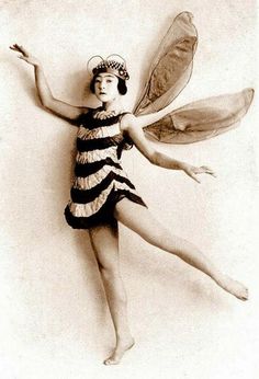 an old photo of a woman dressed as a fairy