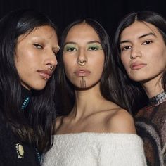 three women with nose piercings standing next to each other