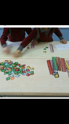 two children are playing with an art project