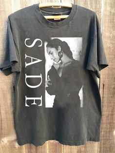 Sade Vintage 90s T-Shirt, Sade Concert Shirt, Sade Pop Music Fan shirt, Sade Gifts for Men Women Unisex Tee, Sade Adu Gift Merch : 100% Cotton (fiber content may vary for different colors) .: Medium fabric (5.3 oz/yd² (180 g/m .: Classic fit .: Runs true to size HOW TO ORDER Pick you favorite design. Review the size & color charts above FIRST and then select shirt size and color from the dropdown menu. Indicate the birthday year in the personalization box. Please note size measurements for t-shi Vintage Letter Print Shirt For Concerts, Sade Concert, Sahm Fashion, Closet Revamp, Sade Adu, Trending Fashion Outfits, Concert Shirts, Cool Graphic Tees, Fan Shirts