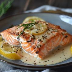 a plate with salmon and lemon slices on it