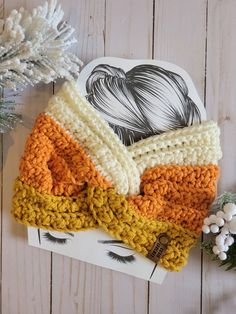 a crocheted headband on top of a white wooden table