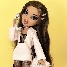 a doll holding a phone up to her ear