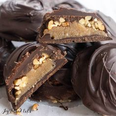 several pieces of chocolate with nuts on top