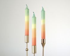 two candles that are sitting next to each other