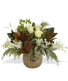 a vase filled with white flowers and greenery next to a pine cone on top